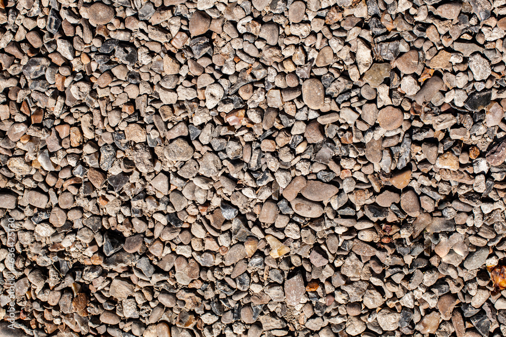 Pebble stones background. Pavement made from natural materials. Top view.