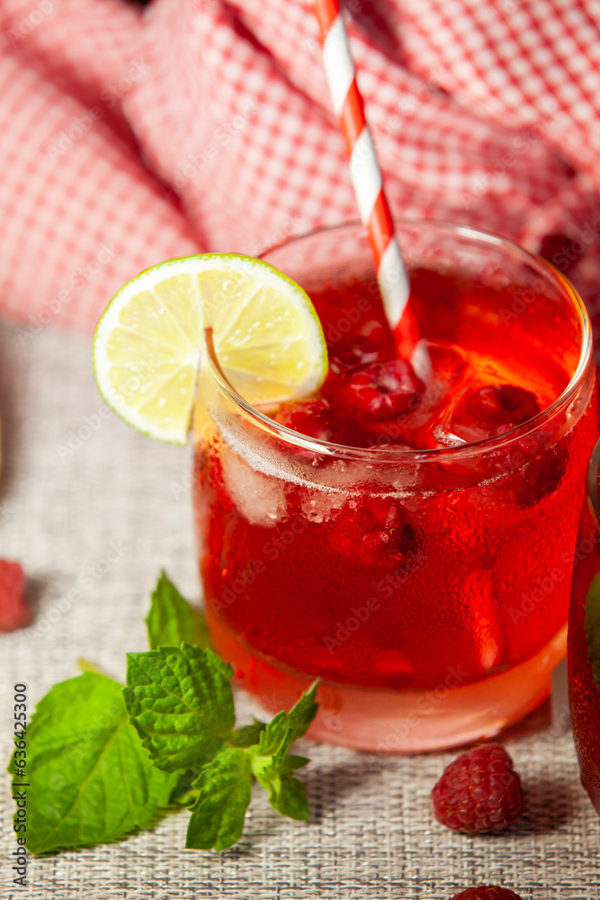 Homemade raspberry lemonade. Non-alcoholic cold drink in a misted glass. Selective focus.