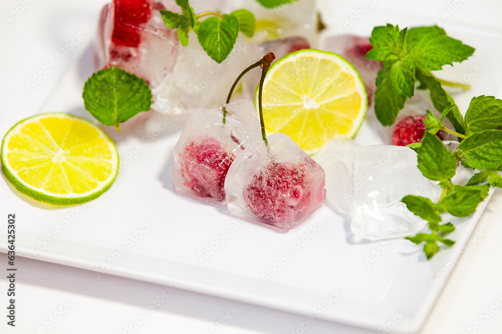 Cherries in ice cubes. Cocktail ingredients. Close-up, selective focus, copy space.