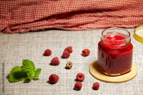 Obraz na płótnie Homemade raspberry jam in a glass jar. Food preservation. Healthy desserts concept. w salonie