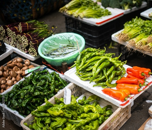 Abundant variety of fresh vegetables and fruits on sale at a vibrant outdoor market stall