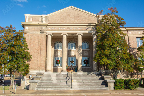 Greek-style temple front view of the Classical Revival style historic First United Methodist Church and community center on Izard Street in Forrest City, Arkansas, USA photo