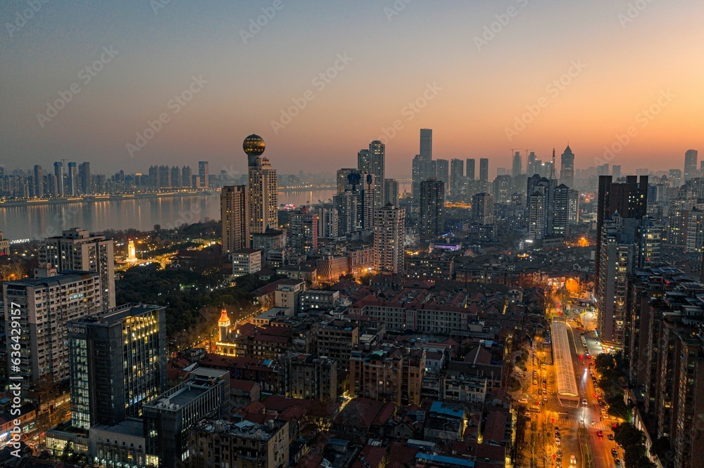 Aerial view of  vibrant night-time cityscape featuring illuminated skyscrapers in Wuhan