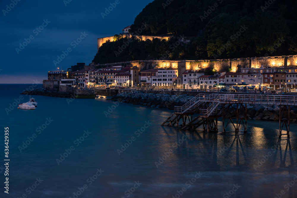 Old port area of San Sebastian-Donostia with La Mota castle illuminated on top at night, Guipuzcoa, Basque country, Spain