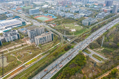 Aerial shot of a cityscape featuring a multitude of highways winding through a bustling urban area