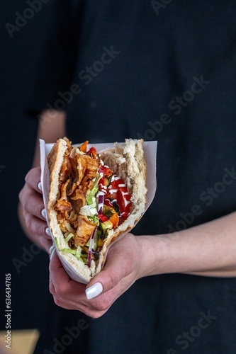 Delicious Berliner doner kebab with fresh turkey and chicken, mixed salad with tomatoes © Nadja Knapp/Wirestock Creators