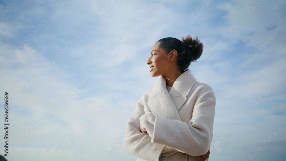 Cheerful woman spinning seashore at cloudy sky. Happy serene girl enjoying rest Cheerful woman spinning seashore at cloudy sky. Happy serene girl enjoying rest