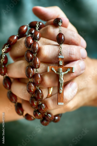 Deeply religious Christian man prays rosary.