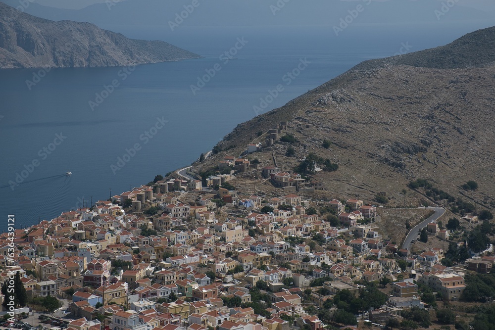 Scenic landscape featuring a mountain side with a clear blue sky, Symi island, Greece