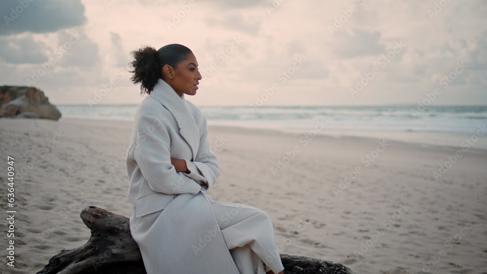Pensive female watching ocean waves resting beach. Lonely black hair woman think Pensive female watching ocean waves resting beach. Lonely black hair woman think