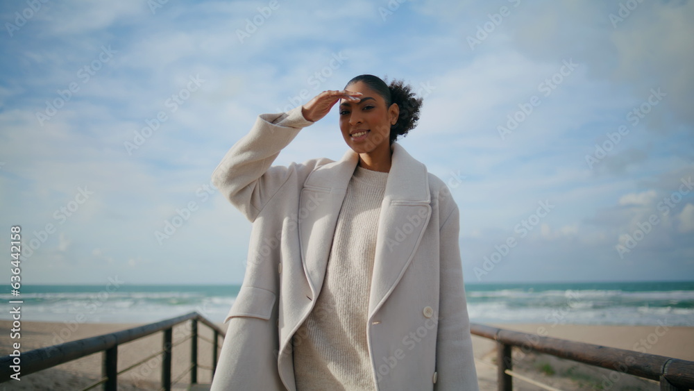 Beautiful woman walking pier at ocean beach. Calm happy tourist admiring nature
