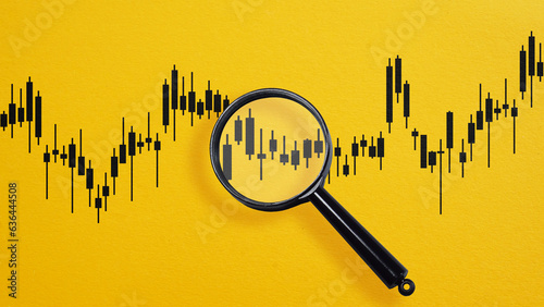 Insider trading. Stock market chart inside magnifier glass. Focus and analysis currency exchange and global trade forex concept. photo