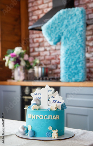 blue cake with the number 1 for 1 year for a boy, a large paper number 1, the inscription 