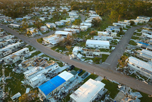 Destroyed by hurricane Ian suburban houses in Florida mobile home residential area. Consequences of natural disaster photo