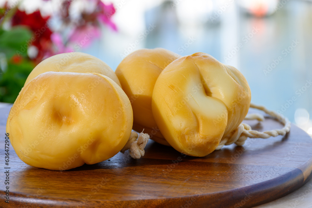 Italian semi hard handmade smoked scamorza cheese, from cow milk from Apulia or Calabria regions close up