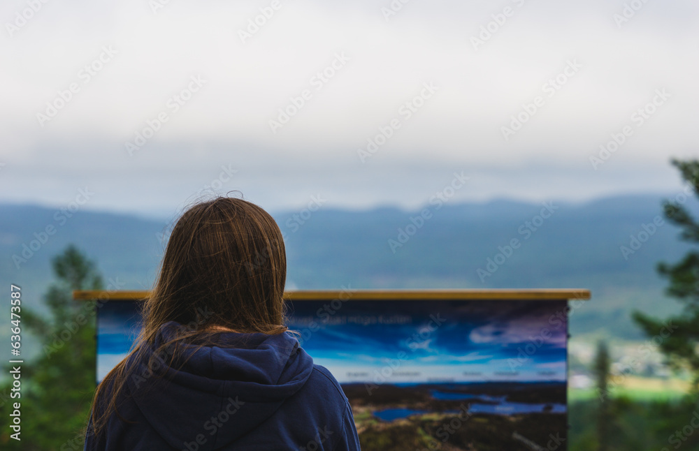 Woman looking out over forest Woman looking out over forest