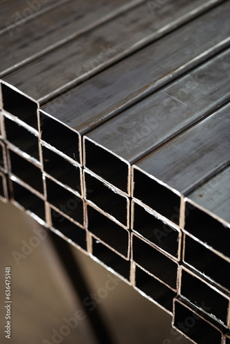 stack​ of square​ metal tubes​ profile or pipes for construction supplies and welding works