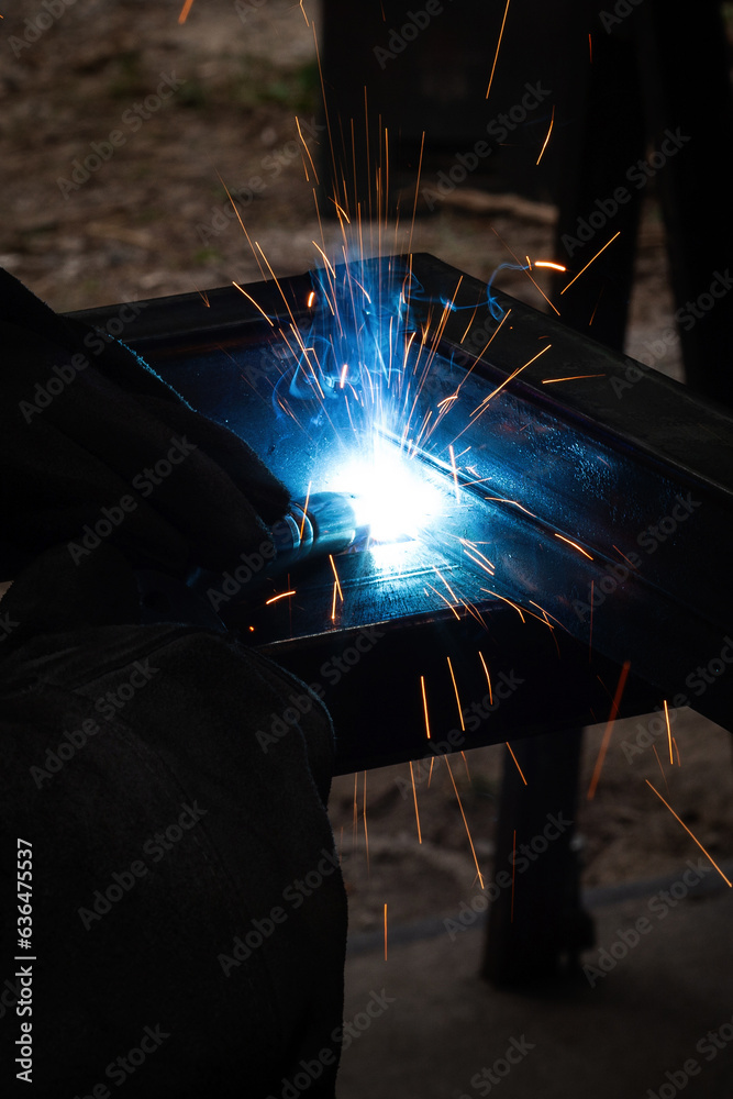 welder, mig or tig welding, craftsman, erecting technical steel Industrial, pretty sparks from weld pistol, steel welder in factory technical