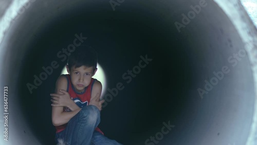 Surviving the Chill: Boy Seeking Solace in the Pipe, Battling the Cold