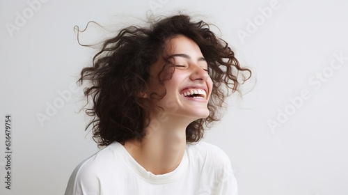 Smiling woman with brunette hair in a studio portrait  radiating beauty and happiness while looking at the camera
