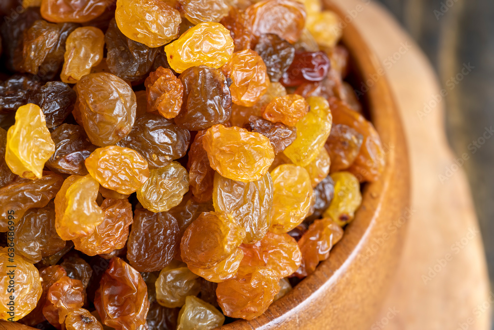 Dried yellow golden raisins on a board