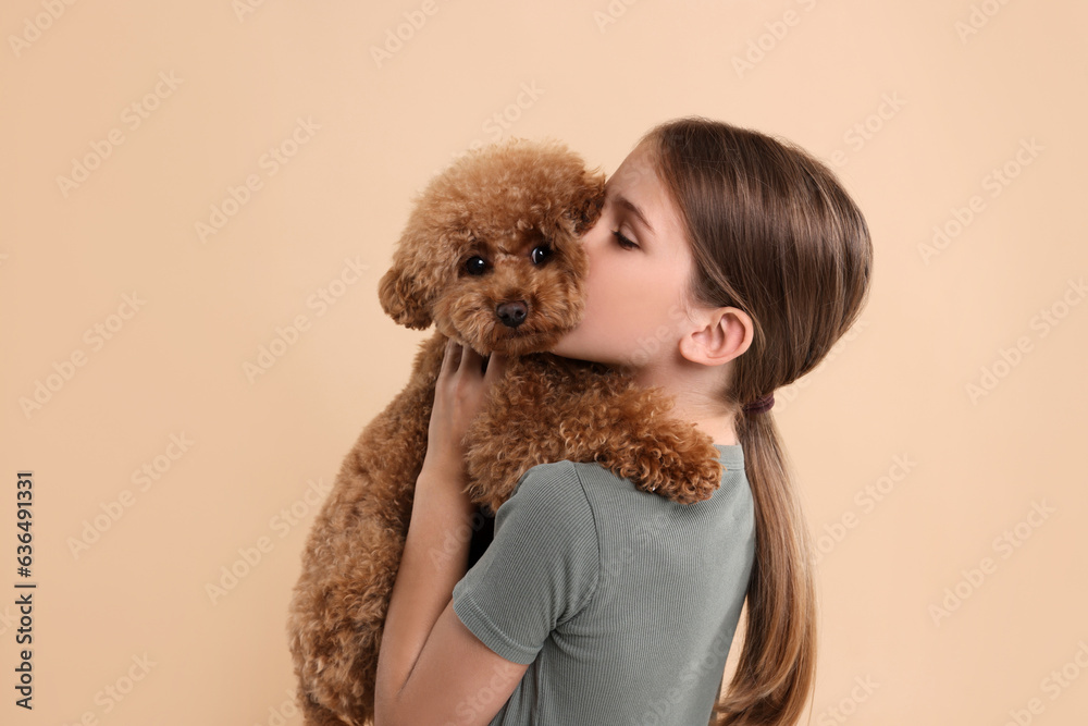 Little child with cute puppy on beige background. Lovely pet Little child with cute puppy on beige background. Lovely pet
