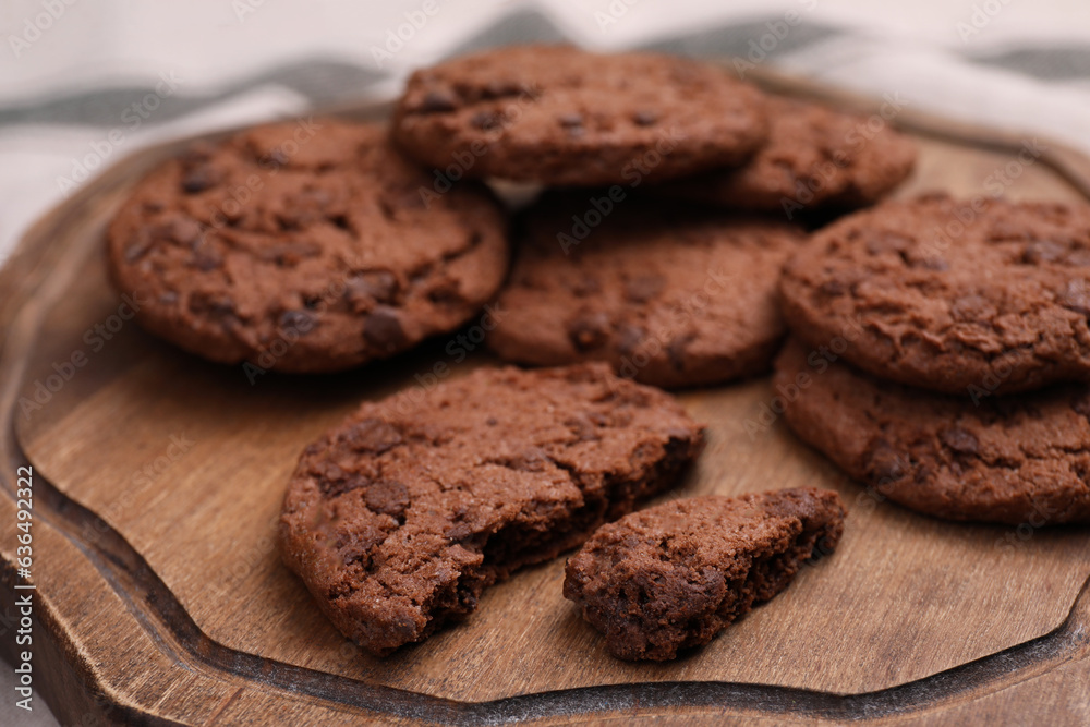 Tasty chocolate cookies on wooden board, closeup