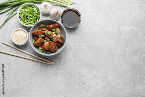 Tasty soy sauce, roasted meat and ingredients on grey table, flat lay. Space for text