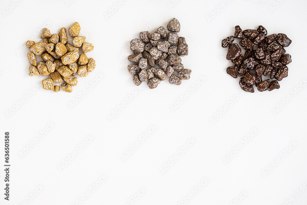 Obraz premium Chocolates pebble. Chocolate candies shaped rock.