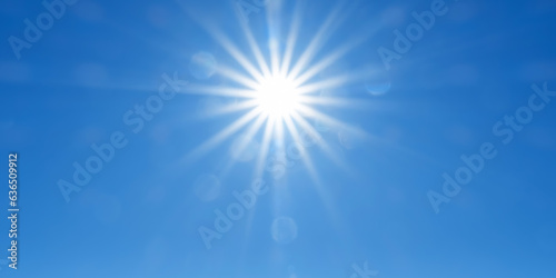 Panoramic sky background with radiant sun beams on bright blue sky