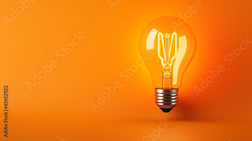 LED filament light bulb with copy space on orange background