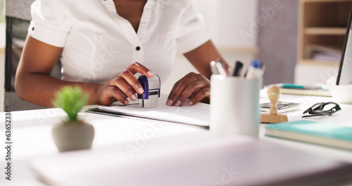 Foto Public Notary Putting Company Stamp On Contract