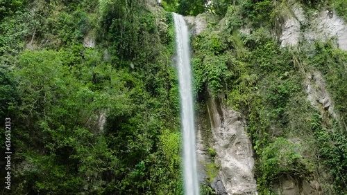 Waterfall among the rainforest and vegetation. Katibawasan Falls in Camiguin Island. Philippines. photo