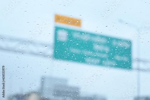 green signpost transport highway on blur background with rainy day