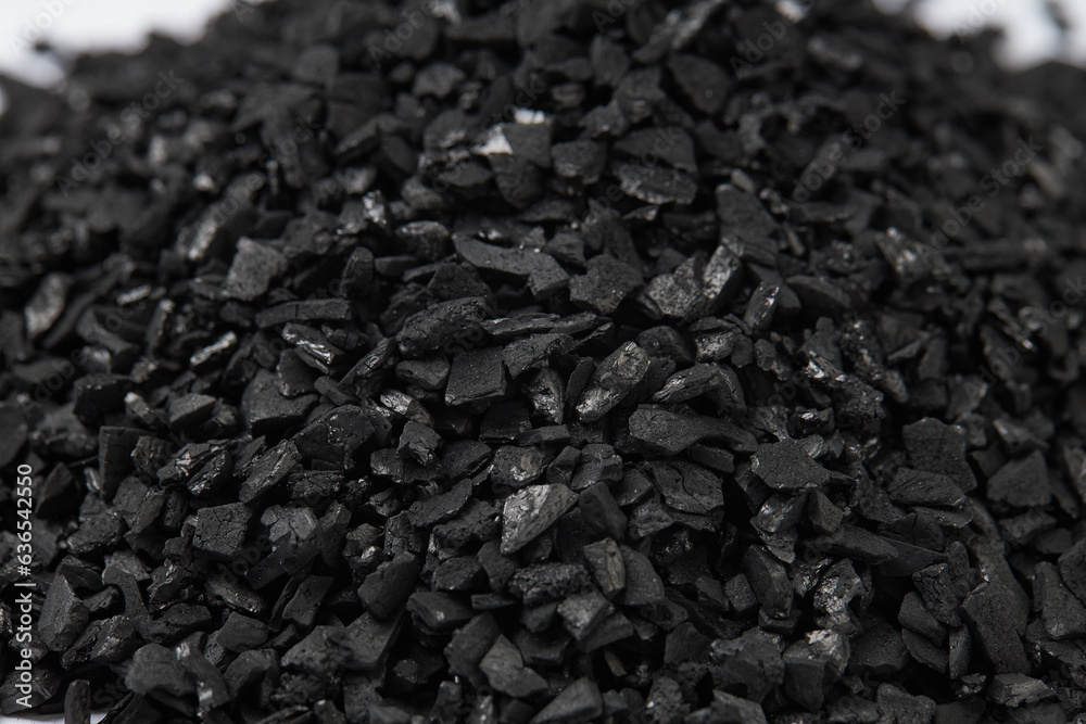 Top view of activated carbon scattered isolated on white background. activated carbon is used for effective application in adsorption, removal of pollutants and water treatment etc. texture background