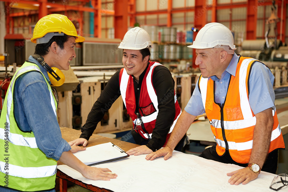 factory workers or engineer planning from work on blueprint drawing paper in the factory factory workers or engineer planning from work on blueprint drawing paper in the factory