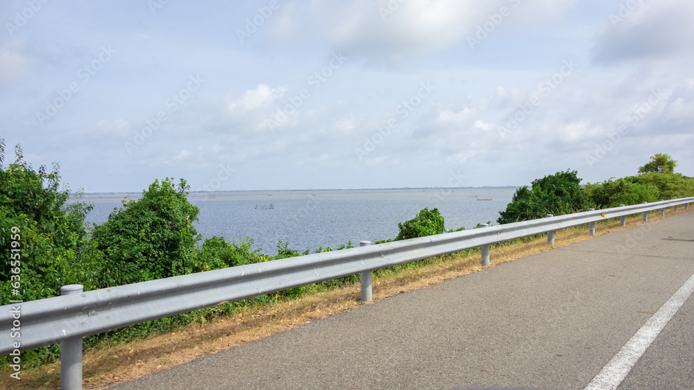 Naklejka premium A huge lake, river by the side of a motorway.