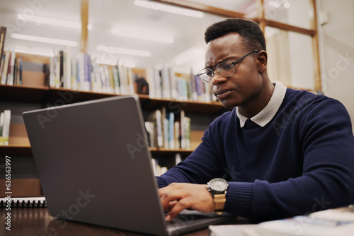 Student, frustrated and black man typing on a laptop in university or college campus angry due to assignment project. Online, studying and young person prepare for internet exam or doing research