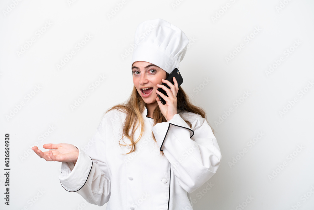 Young caucasian chef woman isolated on white background keeping a conversation with the mobile phone with someone Young caucasian chef woman isolated on white background keeping a conversation with the mobile phone with someone