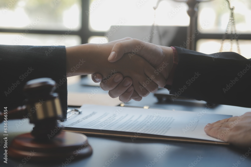 Business and lawyers discussing contract papers with brass scale on desk in office. Law, legal services, advice, justice and law concept picture with film grain effect Business and lawyers discussing contract papers with brass scale on desk in office. Law, legal services, advice, justice and law concept picture with film grain effect