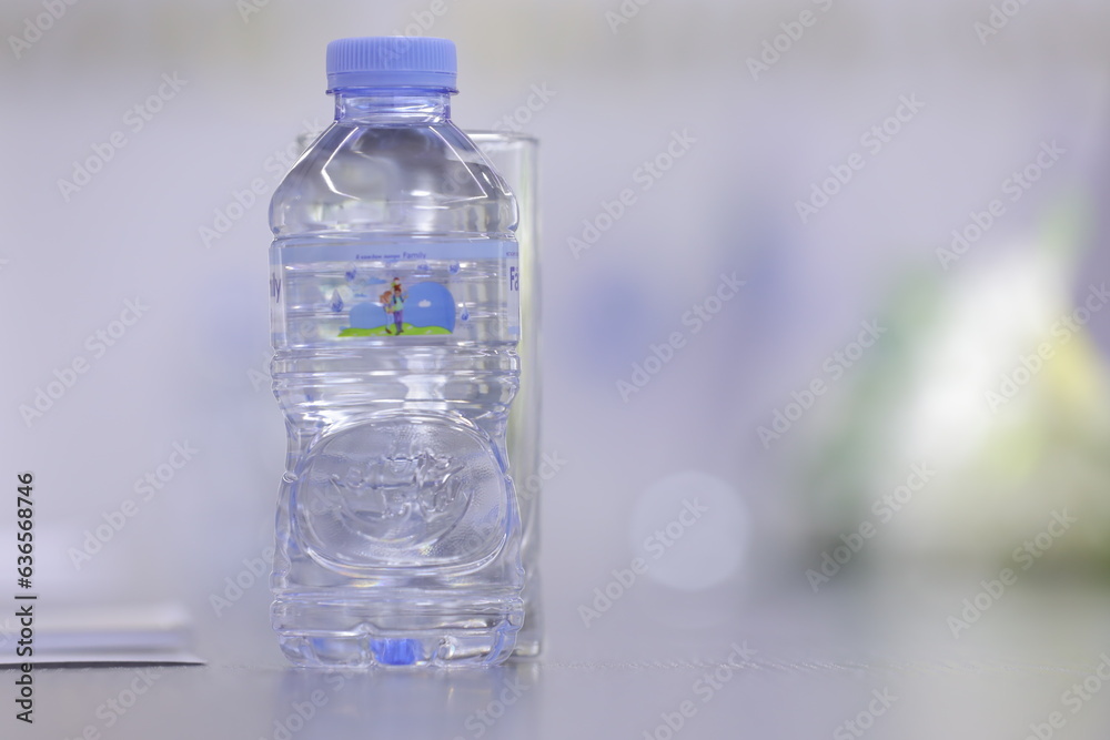 Plastic bottle of water on the table in the office with blurred background Plastic bottle of water on the table in the office with blurred background