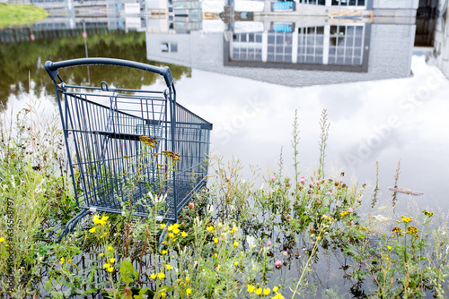 фотографія Lillehammer, Norway,  A shopping mall trolley is submerged in water after heavy rains