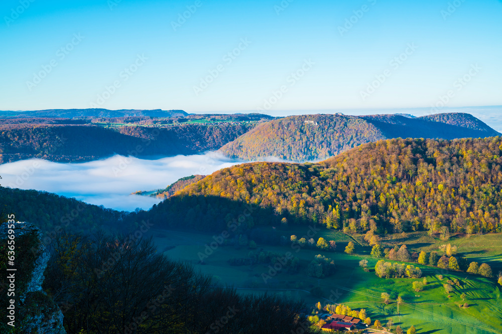 Germany, Castle hohenneuffen aerial panorama view above foggy nature landscape trees valley early morning at sunrise in autumn season