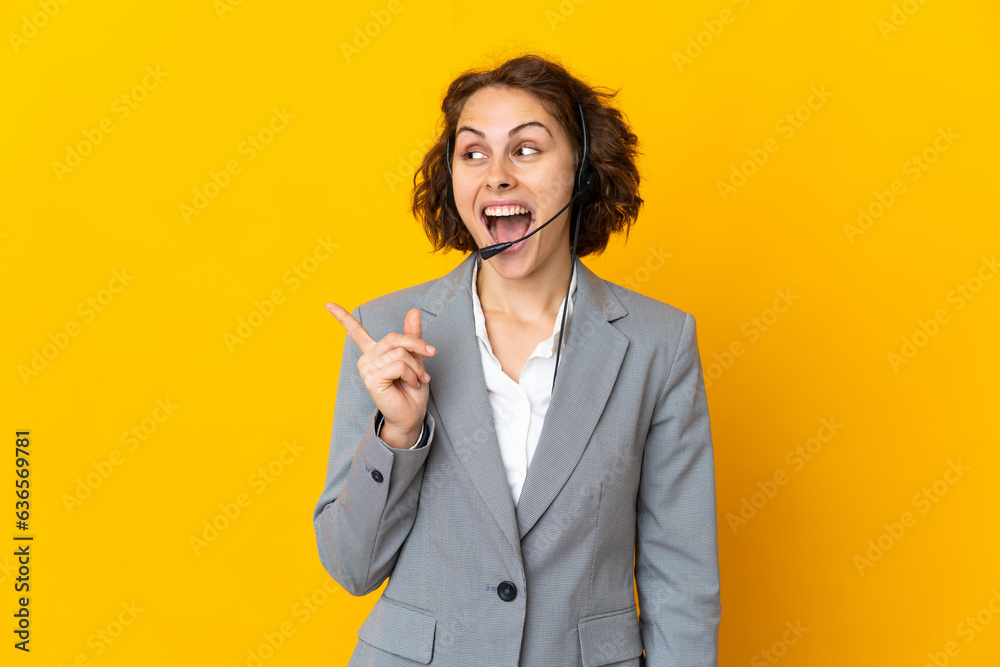 Young English woman isolated on yellow background intending to realizes the solution while lifting a finger up Young English woman isolated on yellow background intending to realizes the solution while lifting a finger up