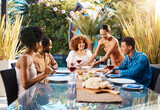 Friends, food and people outdoor at a table for social gathering, happiness and holiday celebration. Diversity, men and women group eating lunch at party or reunion with drinks to relax in a garden