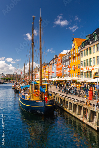 Nyhavn in Copenhagen on a summer afternoon. The colorful facades of the houses create an amazing atmosphere.