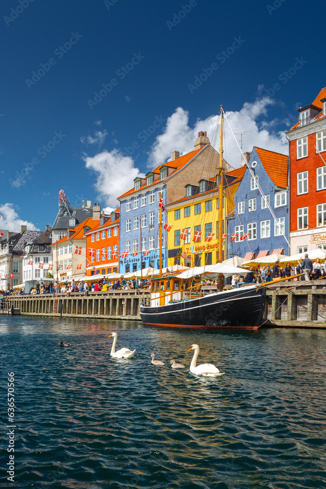 Nyhavn in Copenhagen on a summer afternoon. The colorful facades of the houses create an amazing atmosphere.