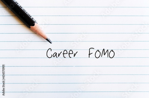 Pencil on office paper with handwritten text CAREER FOMO, means fear of missing out on a job opportunity,  the worry that everyone else is achieving and enjoying more success than you