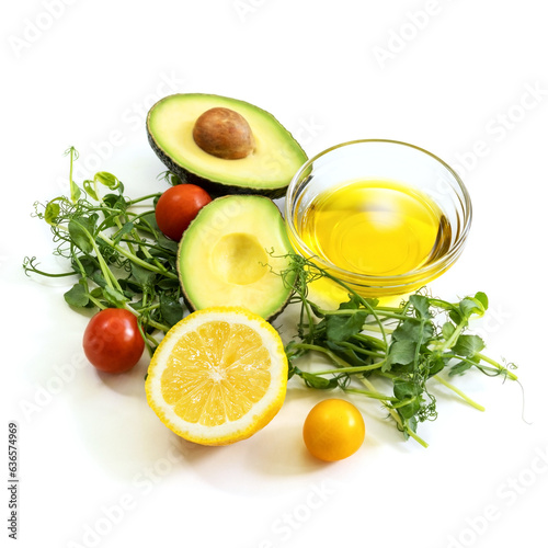 Ingredients of healthy food. Micro green pea sprouts, olive oil, tomato, avocado, lemon. Ketogenic low carbs diet concept. Isolated on a white background