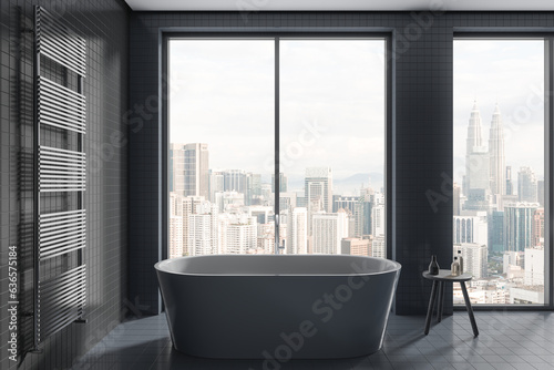 Gray tiled bathroom interior with tub © ImageFlow
